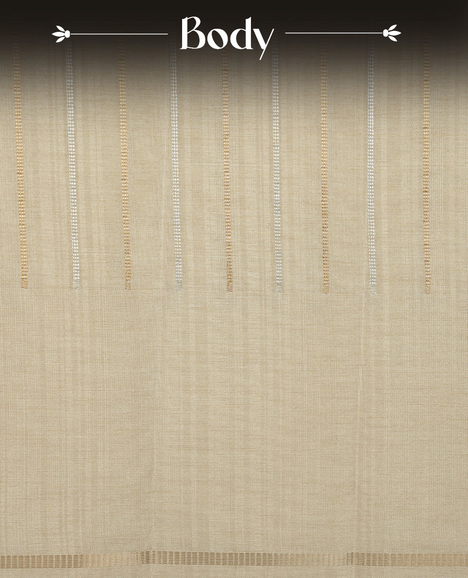 Beige colour semi tussar silk saree highlights gold and silver zari stripes across body,  border, pallu and paired with matching blouse piece.