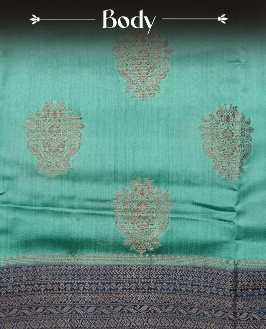 Pastel Aqua Green Colour Tussar Silk saree with elegant antique zari floral motifs On Body, a contrasting Peacock blue zari border, a rich zari pallu, Paired With a matching  blouse piece.