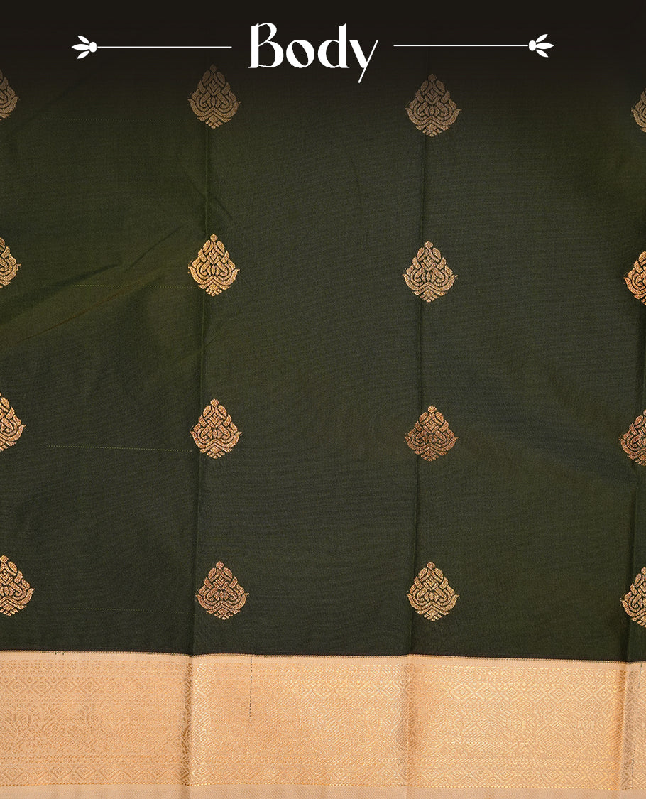 Dark green coloured soft silk saree featuring gold zari motifs across the body, enhanced with a contrast Cream border and pallu, paired with a matching contrast blouse piece.