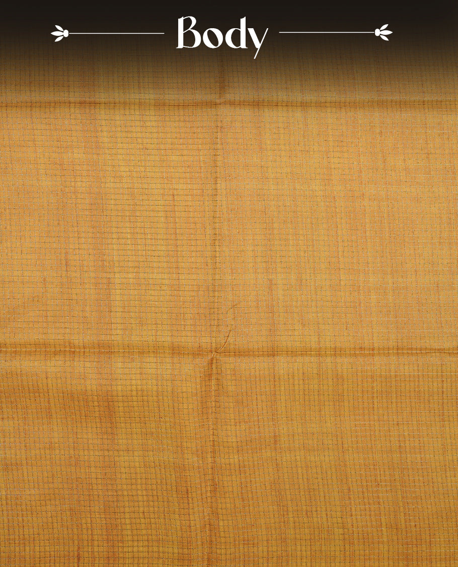 Golden yellow colour semi tussar silk saree featuring an all-over elephant motif print across the body, complemented by a contrasting pallu and border, and paired with a matching blouse piece.