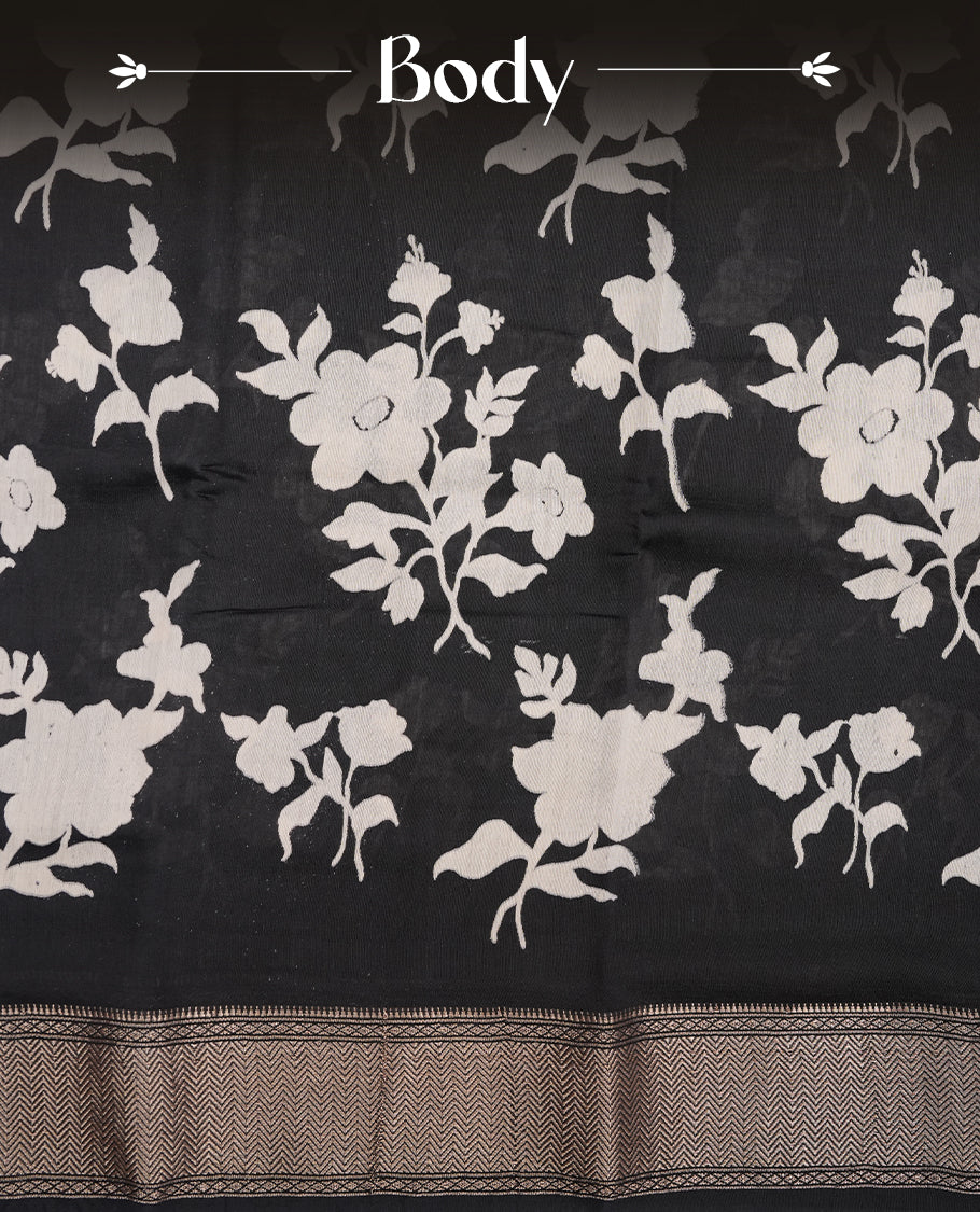 Black colour Viscos semi printed saree featuring a light golden zari border, abstract off white printed motifs on the body, and comes with a matching blouse