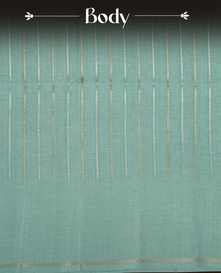 Pastel aqua colour semi tussar silk saree highlights gold and silver zari stripes across body,  border, pallu and paired with matching blouse piece.