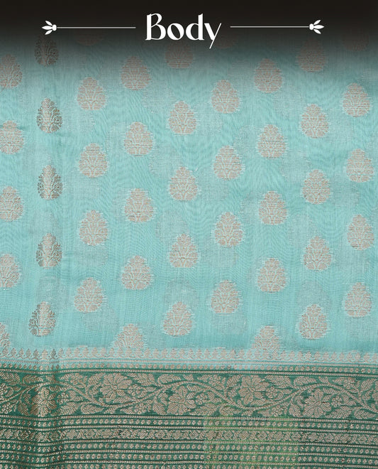Light Sea Green Colour Tussar Silk saree adorned with antique zari butta motifs across the body, complemented by a contrasting bottle green floral zari border and pallu, paired with a matching blouse piece.