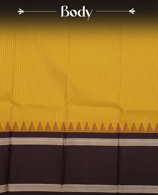 Mustard yellow colour soft silk saree featuring gold zari stripes on body, contrast dark chocolate colour gold zari simple border, grand pallu comes with matching blouse piece.