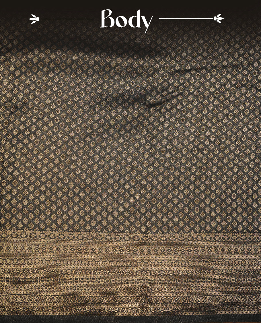 Black colour semi soft silk saree featuring gold zari motifs on across body, self colour border with traditional gold zari pattern, pallu and paired with matching blouse.