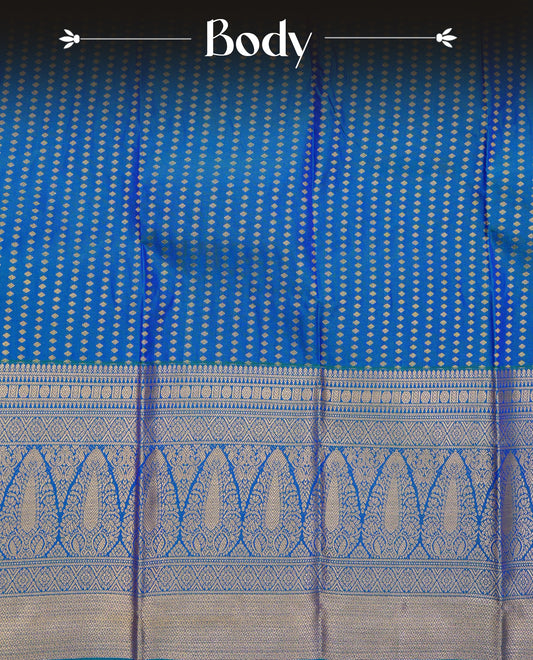 Peacock blue colour soft silk saree featuring gold zari buttas on body, contrast self colour gold zari traitionl border, grand pallu comes with matching blouse piece.