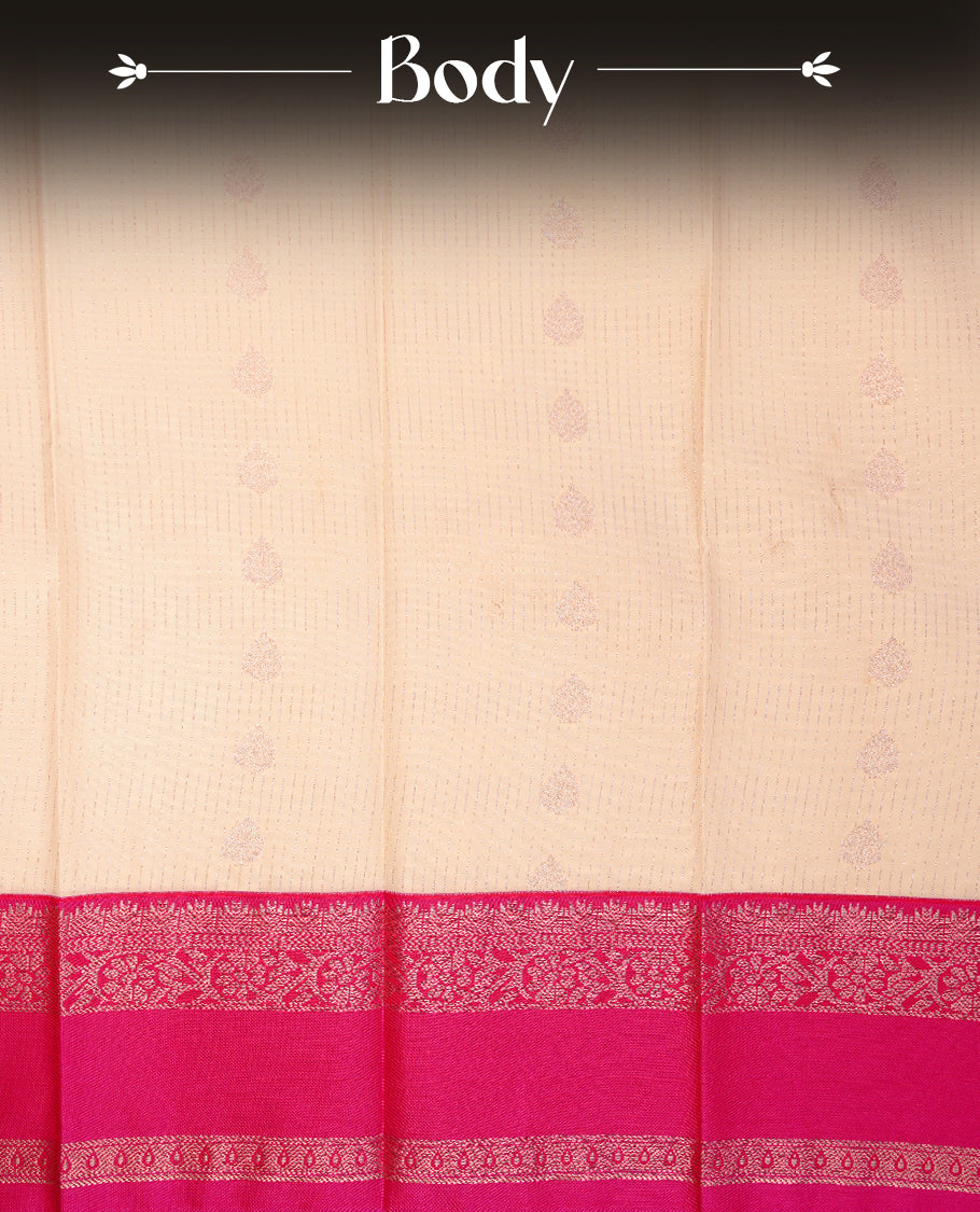 Cream coloured soft silk saree featuring gold zari stripes and motifs across the body, enhanced with a contrast Magenta border and pallu, paired with a matching contrast blouse piece.