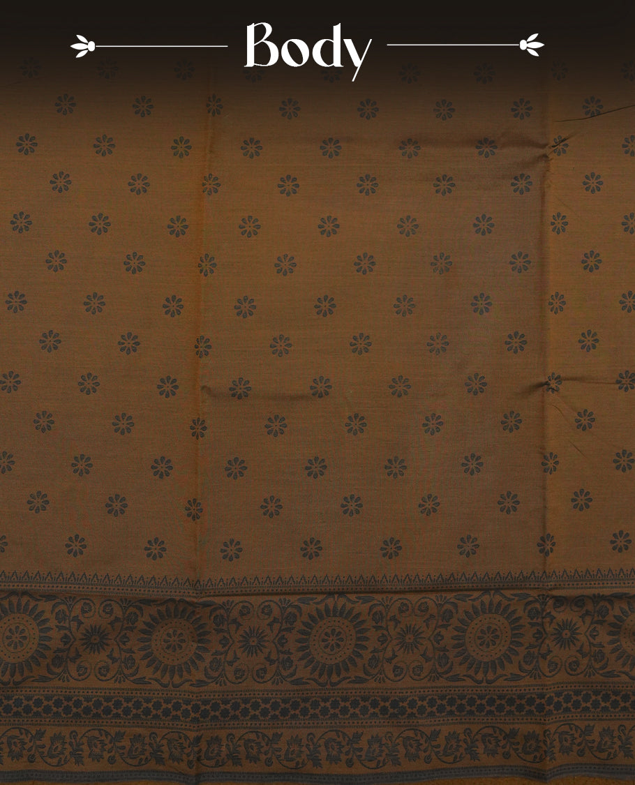 Brown colour poly cotton saree with black floral butti motifs on the body, paired with a matching pallu featuring black ornate floral jaal and stripes on the border, and a coordinated all‑over black paisley printed blouse piece.