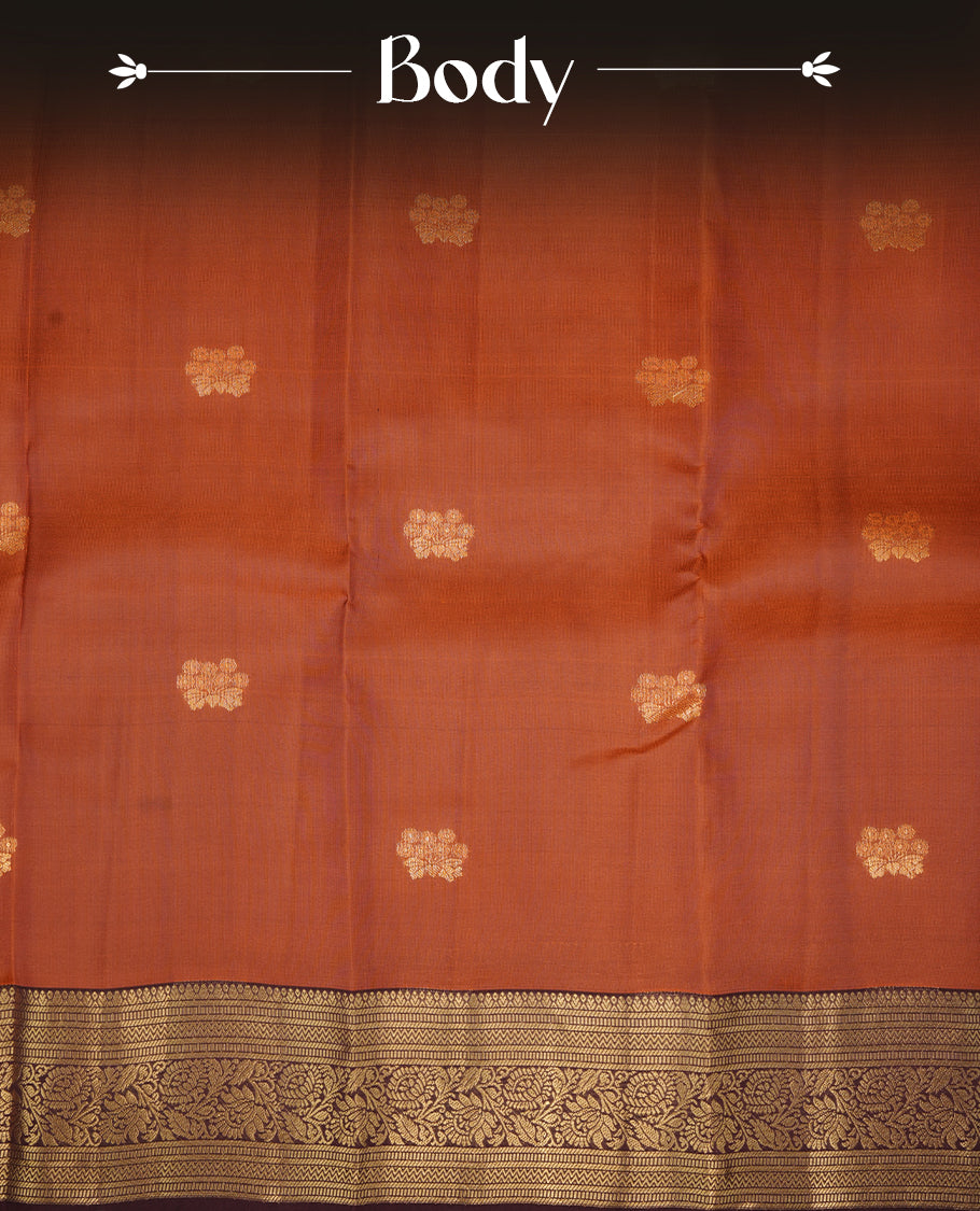 Rust colour soft silk saree featuring gold zari motifs on the body, complemented by a contrast Chocolate traditional zari floral kodi border and pallu, paired with a matching blouse piece.