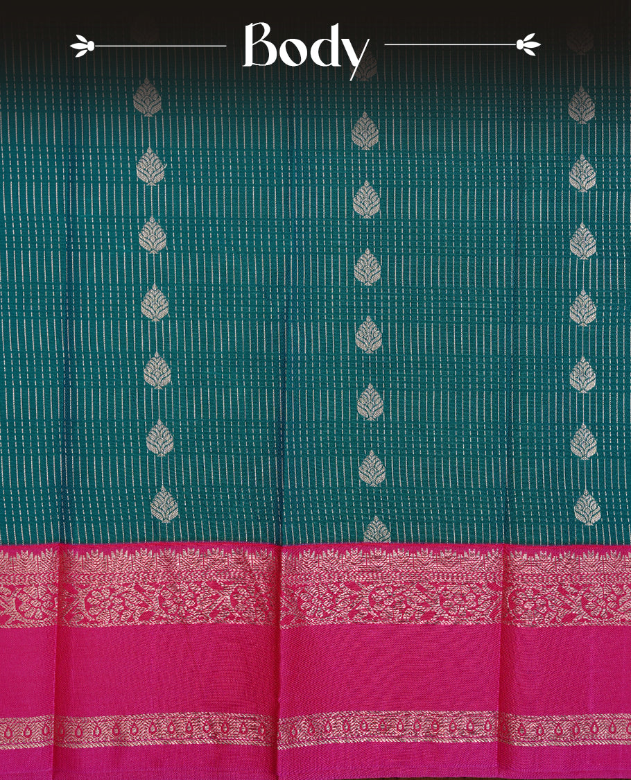 Teal coloured soft silk saree featuring gold zari stripes and motifs across the body, enhanced with a contrast Magenta border and pallu, paired with a matching contrast blouse piece.