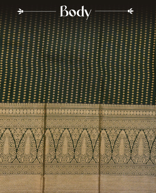 Dark green colour soft silk saree featuring gold zari buttas on body, contrast self colour gold zari traditonal border, grand pallu comes with matching blouse piece.