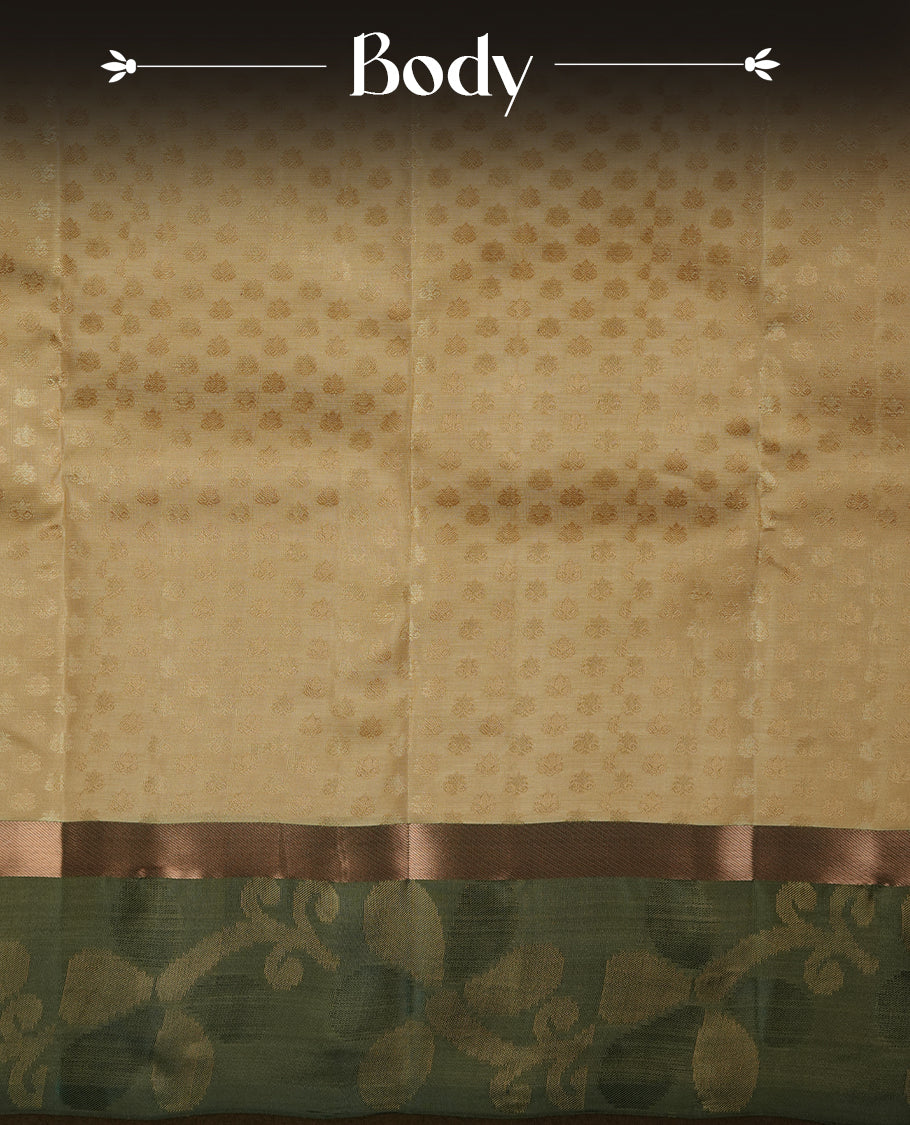 Light gold colour soft silk saree featuring gold zari motifs on the body, complemented by a contrast green zari floral kodi border and pallu, paired with a matching blouse piece.