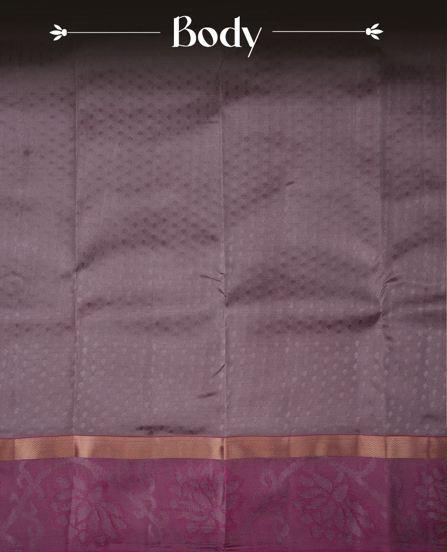 Dusty lavender colour soft silk saree featuring gold zari motifs on the body, complemented by a contrast magenta traditional zari floral kodi border and pallu, paired with a matching blouse piece.