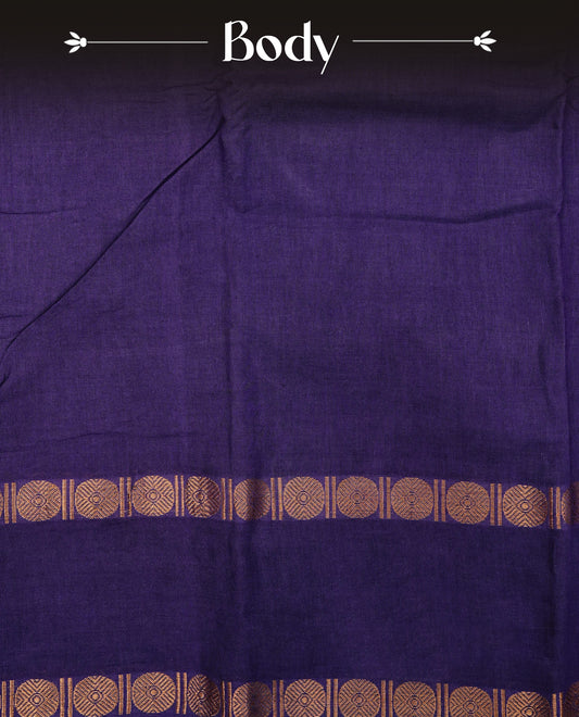 Purple Colour  Sungudi Cotton Saree with gold zari motifs on the body, a matching gold zari border, and a plain pallu. Paired with a contrast Pink colour  blouse piece  featuring a gold zari peacock border.