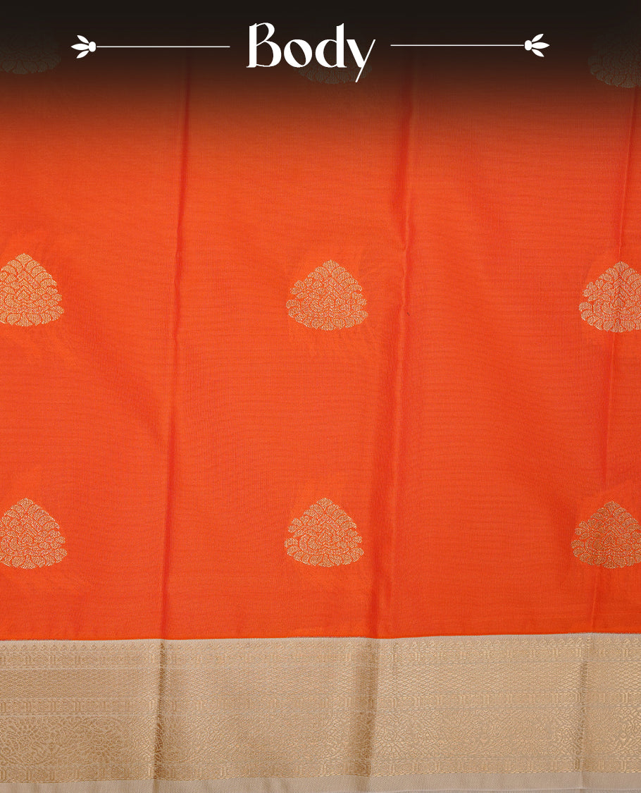 Orange coloured soft silk saree featuring gold zari motifs across the body, enhanced with a contrast Cream border and pallu, paired with a matching contrast blouse piece.