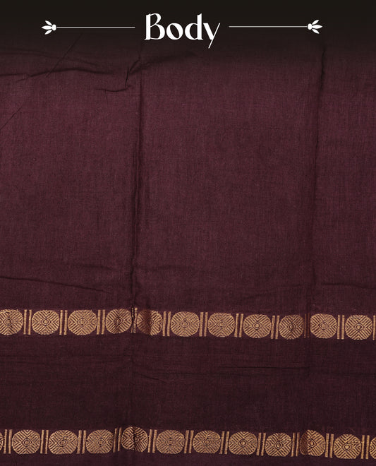 Dark Wine Colour  Sungudi Cotton Saree with gold zari motifs on the body, a matching gold zari border, and a plain pallu. Paired with a contrast Reddish Pink colour  blouse piece  featuring a gold zari peacock border.