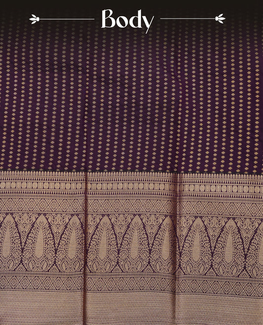 Dark purple colour soft silk saree featuring gold zari buttas on body, contrast self colour gold zari traditional border, grand pallu comes with matching blouse piece.
