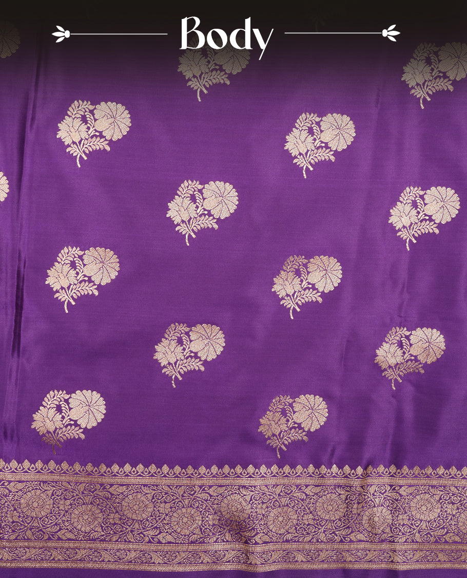 Purple colour Banaras Satin Crepe saree featuring gold zari floral motifs on the body, a richly woven traditional border with intricate gold zari detailing, and paired with a matching blouse.