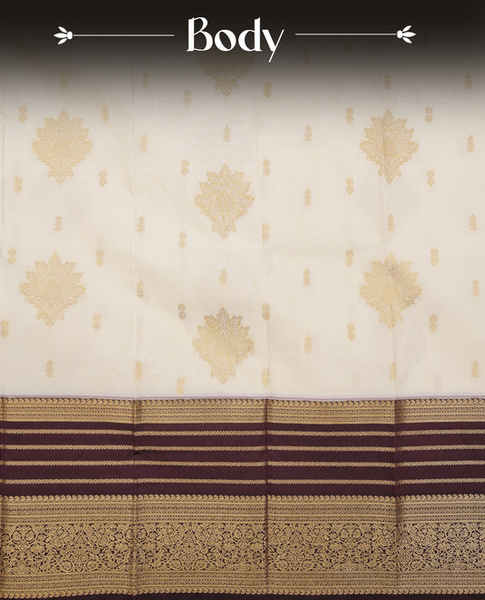 Cream colour soft silk saree featuring gold zari floral motifs & buttas on body, contrast brown colour gold zari traditional border, grand pallu comes with matching blouse piece.