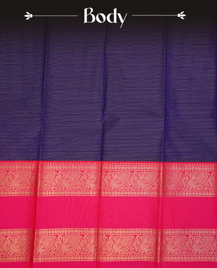 Navy blue coloured soft silk saree featuring gold zari stripes and motifs across the body, enhanced with a contrast Magenta border and pallu, paired with a matching contrast blouse piece.