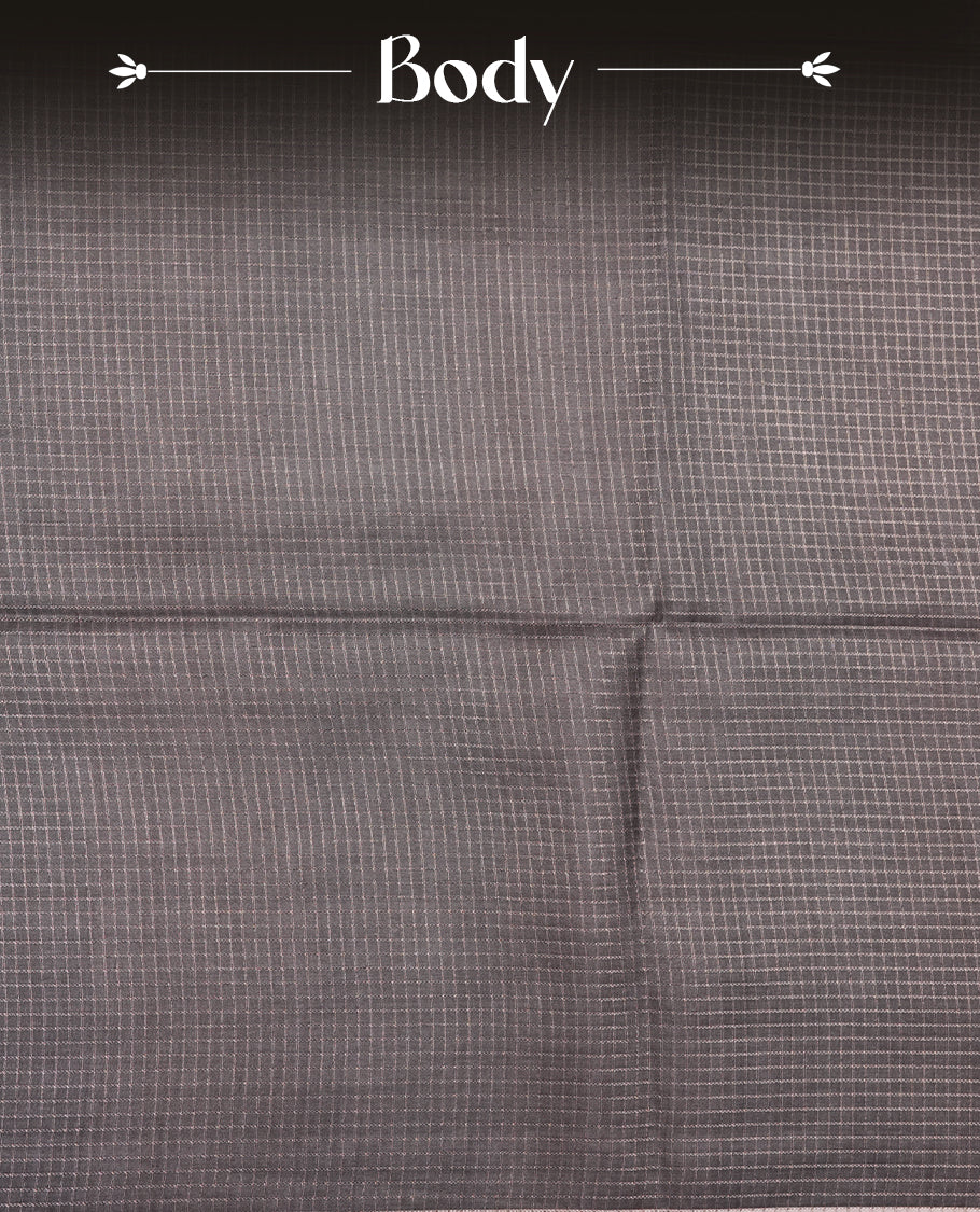 Charcoal green colour semi tussar silk saree featuring an all-over elephant motif print across the body, complemented by a contrasting blue pallu and border, and paired with a matching blouse piece.