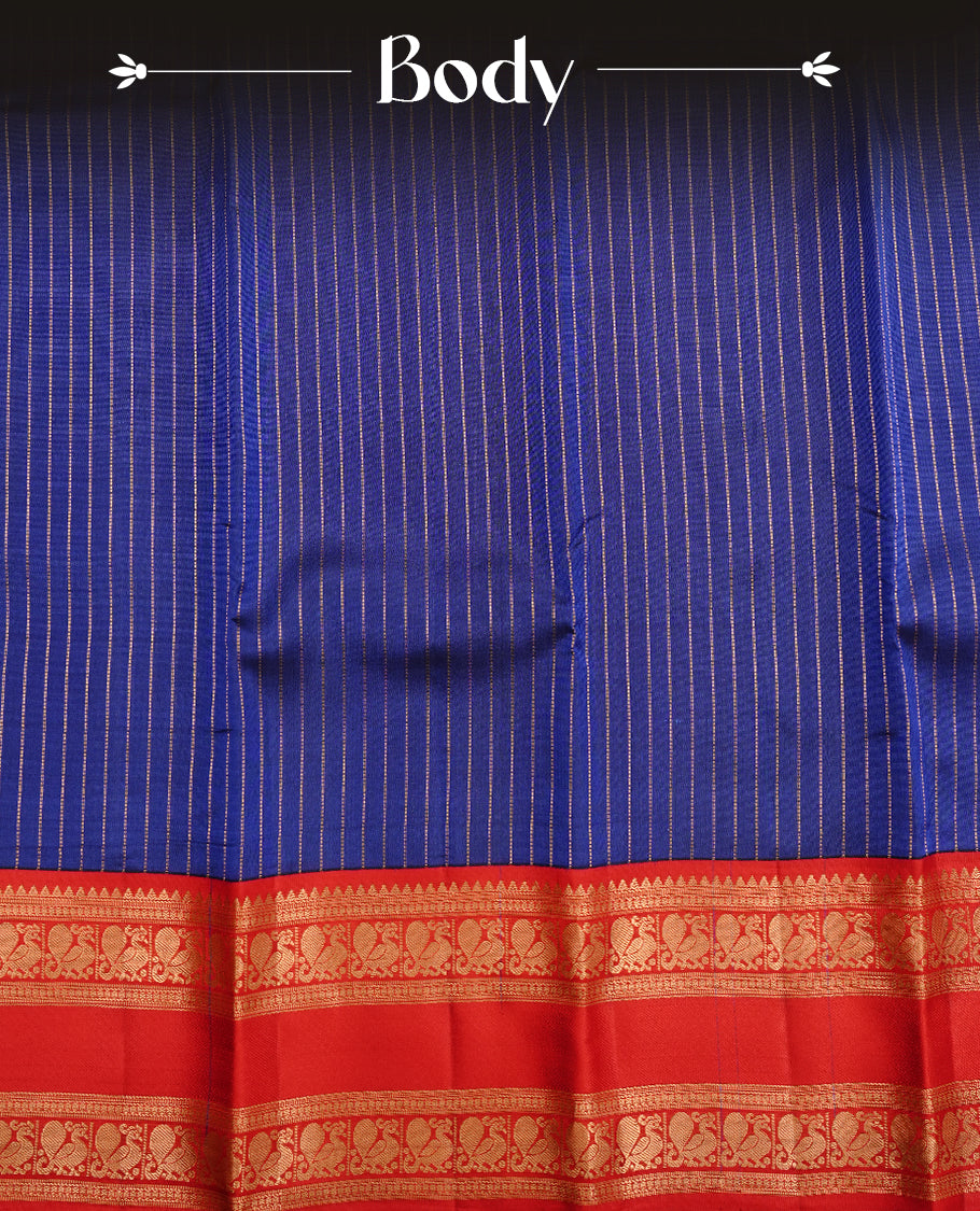 Navy blue colour traditional kancheepuram silk saree featuring gold zari strpies on body, complemented by contrast red colour with gold zari traditional border, paired with matching blouse piece.