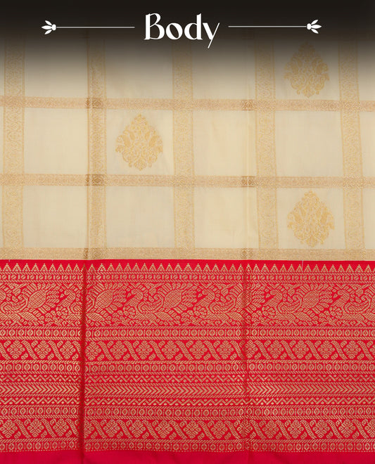 Cream colour soft silk saree featuring gold zari checks with floral mottifs on body, contrast reddish pink colour gold zari pecock traditional border, grand pallu comes with matching blouse piece.