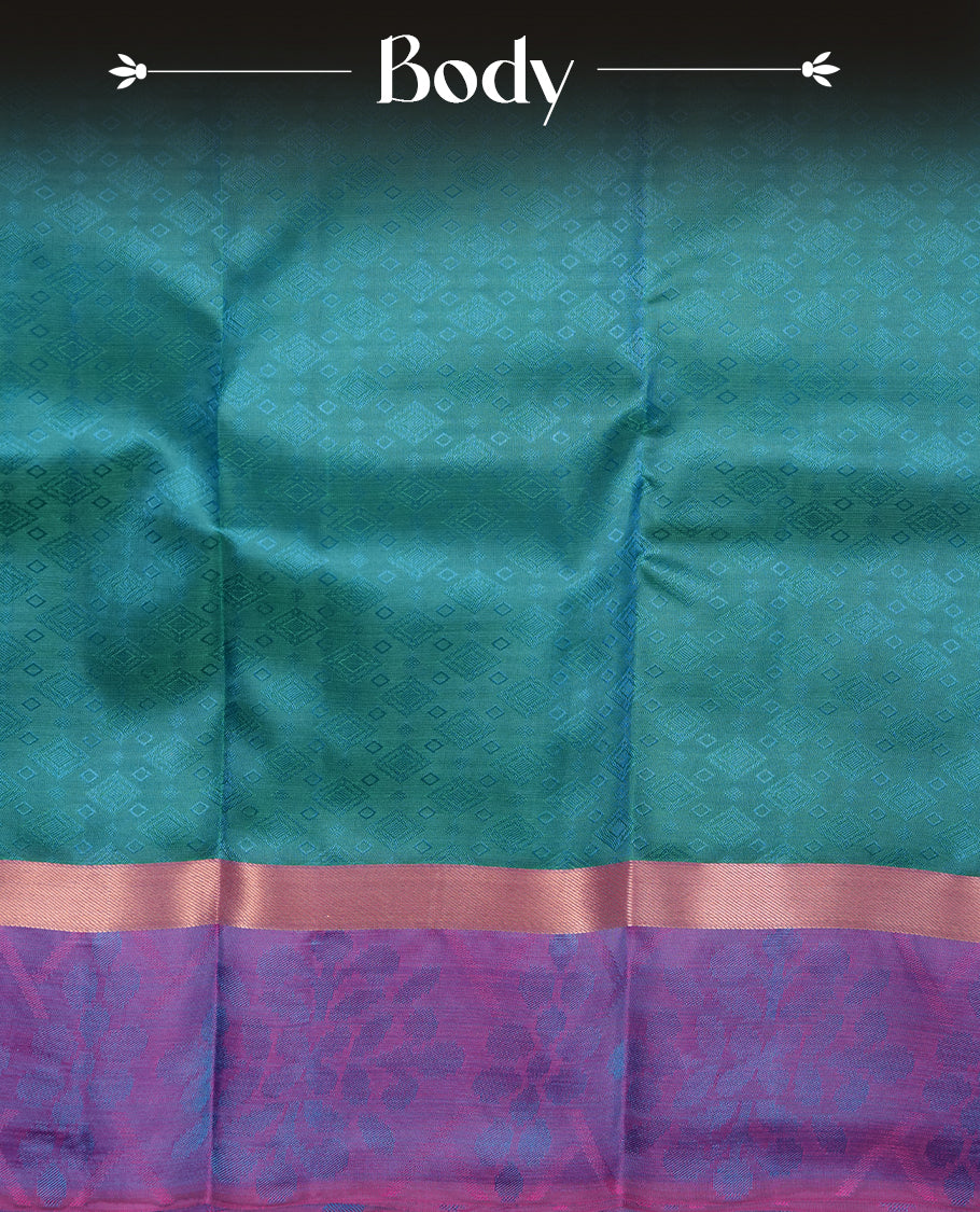 Peacock colour soft silk saree featuring gold zari motifs on the body, complemented by a contrast Indigo traditional zari kodi border and pallu, paired with a matching blouse piece.