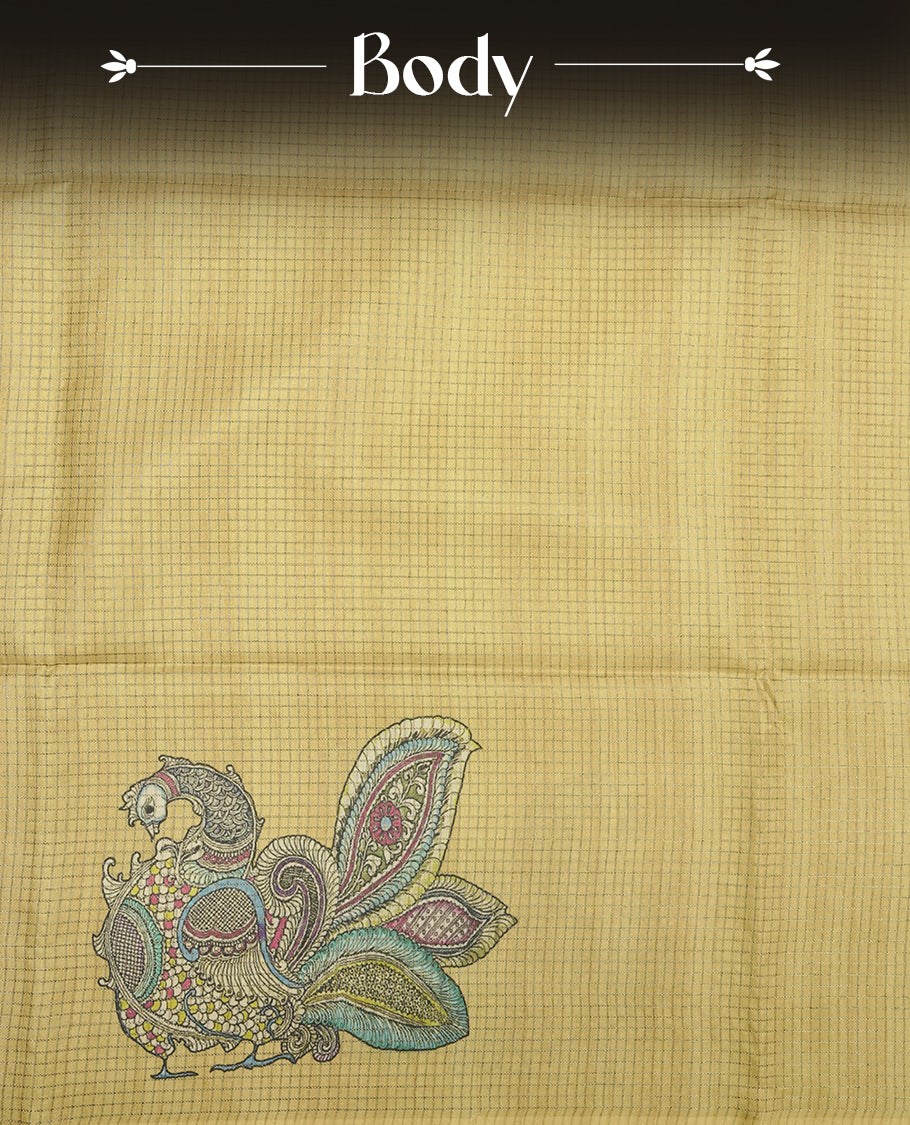 Mustard yellow colour semi tussar silk saree with Kalamkari-inspired peacock pallu, floral printed body, subtle textured weave, and tassel finish, paired with a matching printed blouse piece.