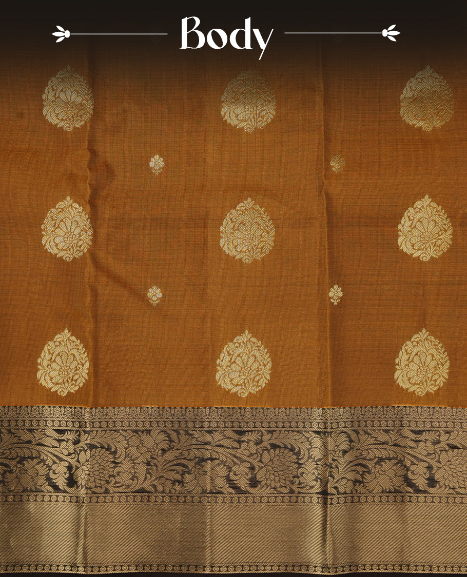 Mustard colour soft silk saree featuring gold zari motifs on the body, complemented by a contrast chocolate brown traditional zari border and pallu, paired with a matching blouse piece.