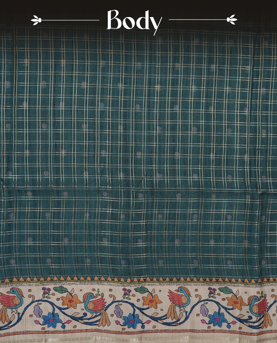 Dark green colour semi tusser silk saree featuring gold zari check pattern with floral butti motifs, with contrast floral kodi & bird pattern and paired with matching blouse.
