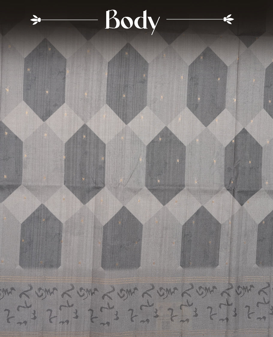 Gray colour semi tusser silk saree featuring geometric print pattern across body, gold zari border with style motifs and paired with matching blouse.