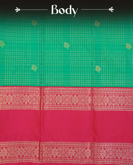 Teal green colour soft silk saree featuring gold zari checks with buttas on body, contrast rani pink colour gold zari floral traditional border, grand pallu comes with matching blouse piece.