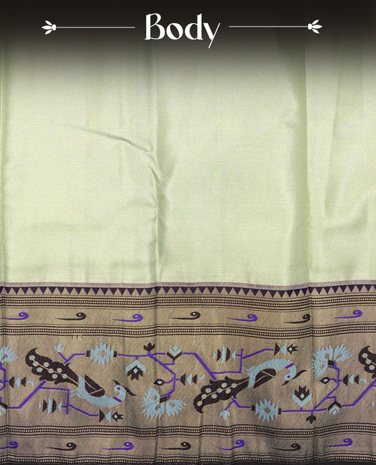 Light Green Colour Semi Tissue Silk Saree featuring a Plain body, complemented by an intricately woven floral zari pallu, a rich Dark Chocolate Brown and gold zari border, and paired with a matching plain blouse piece