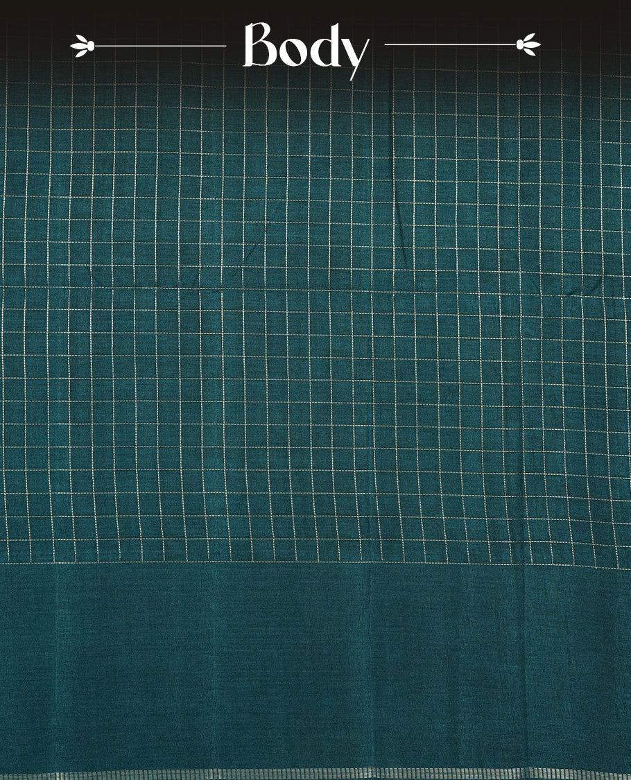 Teal colour semi Tussar saree highlights gold zari check pattern across body,  border, pallu and paired with matching blouse piece.