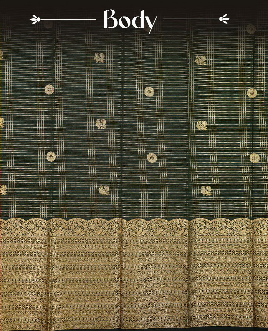 Dark green coloured soft silk saree featuring gold zari stripes and motifs across the body, enhanced with selfcolour border and pallu, paired with a matching blouse piece.