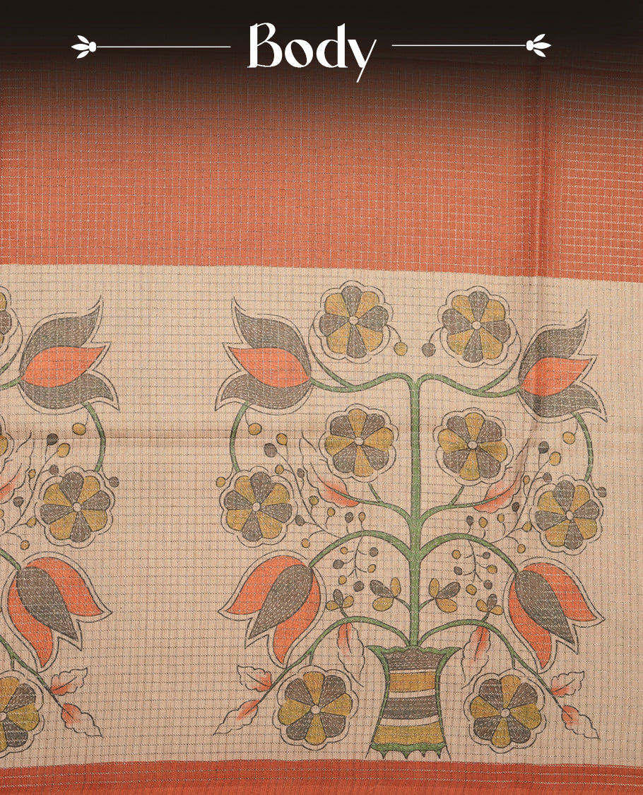 Wheat colour semi tussar silk saree featuring floral print and zari check pattern across body, contrast burnt orange colour border and pallu, paired with matching blouse piece.