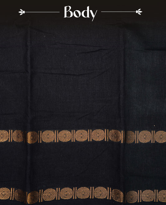 Black Colour  Sungudi Cotton Saree with gold zari motifs on the body, a matching gold zari border, and a plain pallu. Paired with a contrast Orange colour  blouse piece  featuring a gold zari peacock border.