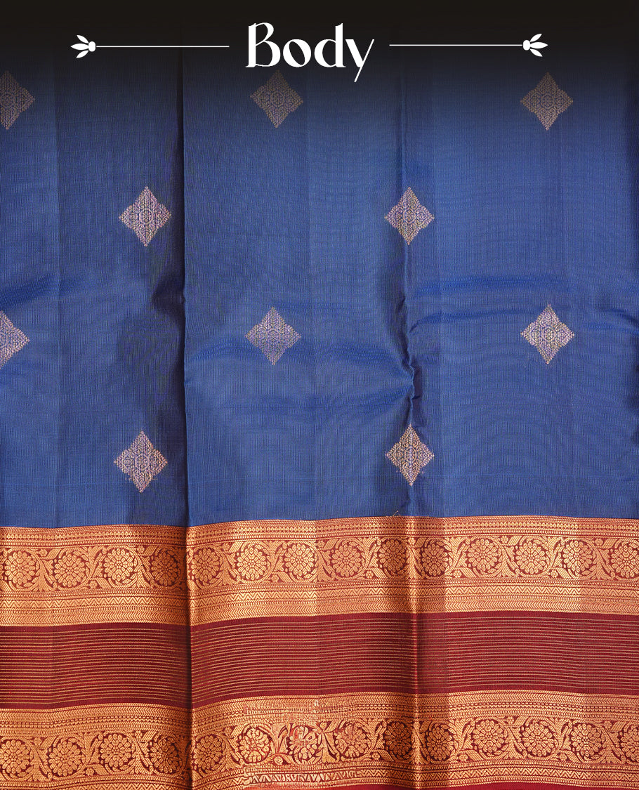 Navy blue colour traditional kancheepuram silk saree featuring gold zari strpies on body, complemented by contrast maroon colour with gold zari traditional border, paired with matching blouse piece.