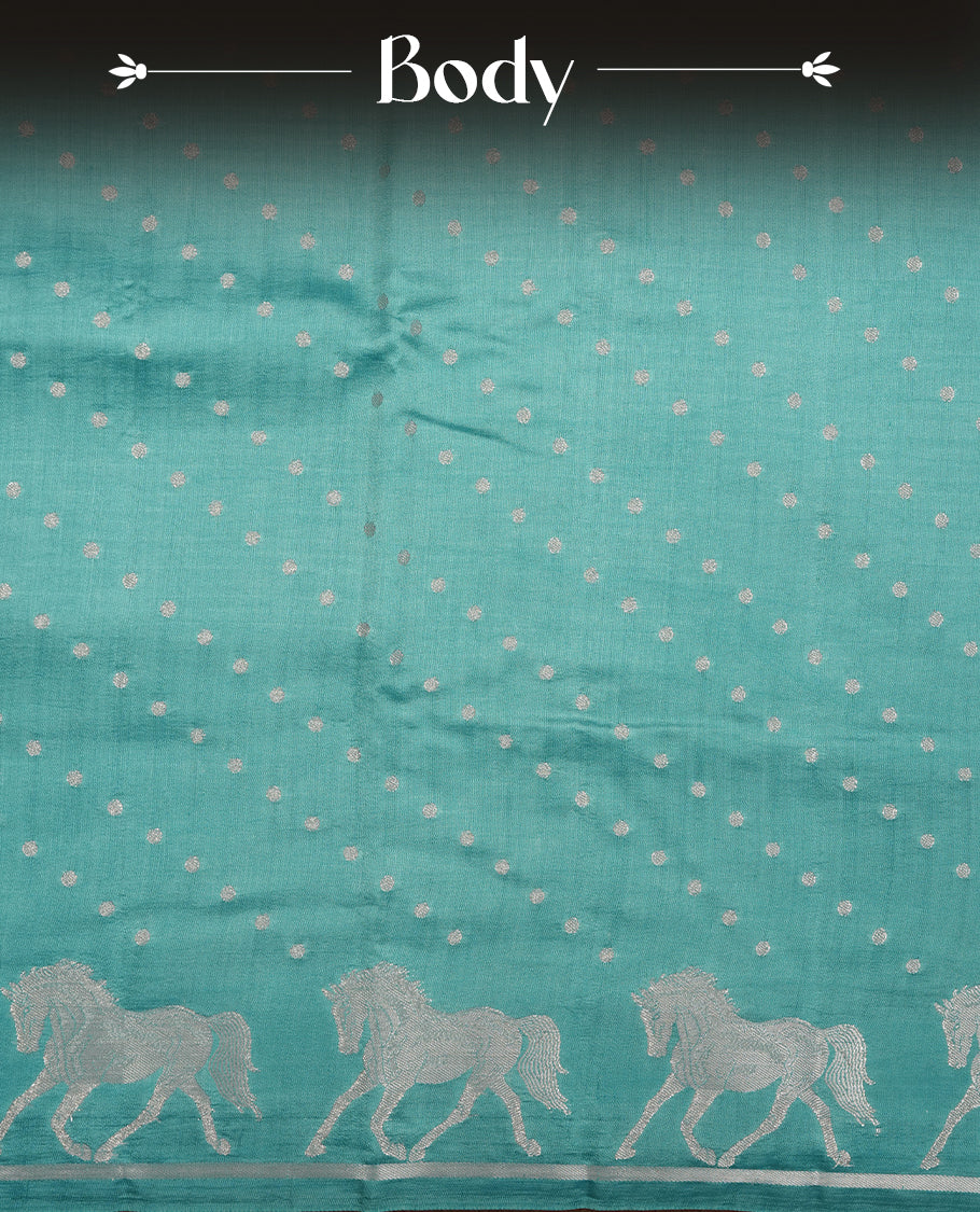 Pastal blue colour banaras soft silk saree featuring silver zari dotted stripes on body, self colour border with silver horse pattern, pallu and paired with matching blouse.