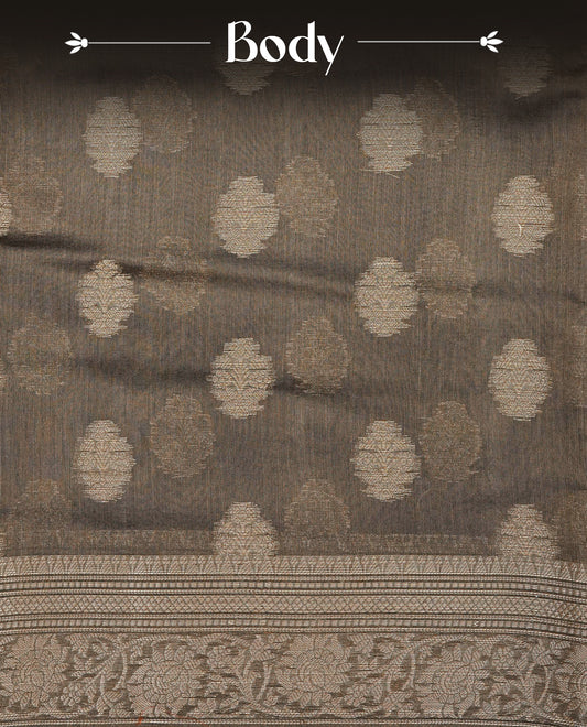 Khaki Brown Colour Tussar Silk saree with antique zari butta motifs On Body, a self-toned floral zari border, a rich zari pallu, and a matching blouse piece.