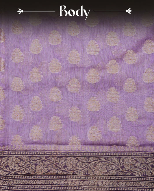 Light Purple Colour Tussar Silk saree adorned with antique zari butta motifs across the body, complemented by a contrasting Purple floral zari border and pallu, paired with a matching blouse piece.