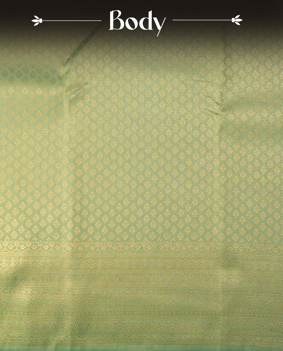 Ice green colour semi soft silk saree featuring gold zari motifs on across body, self colour border with traditional gold zari pattern, pallu and paired with matching blouse.