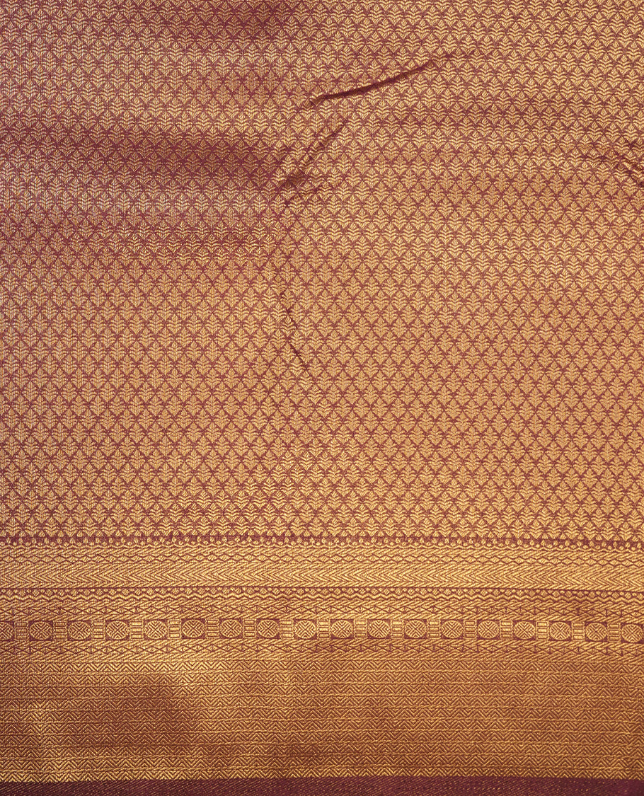 Meganta colour semi soft silk saree featuring gold zari motifs on across body, self colour border with traditional gold zari pattern, pallu and paired with matching blouse.