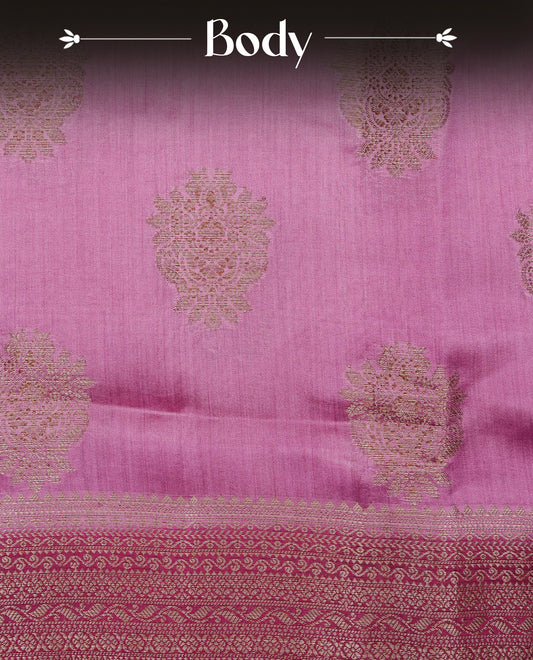 Pastel Orchid Pink Colour Tussar Silk saree with elegant antique zari floral motifs On Body , a contrasting magenta zari border, a rich zari pallu, Paired With a matching blouse piece.
