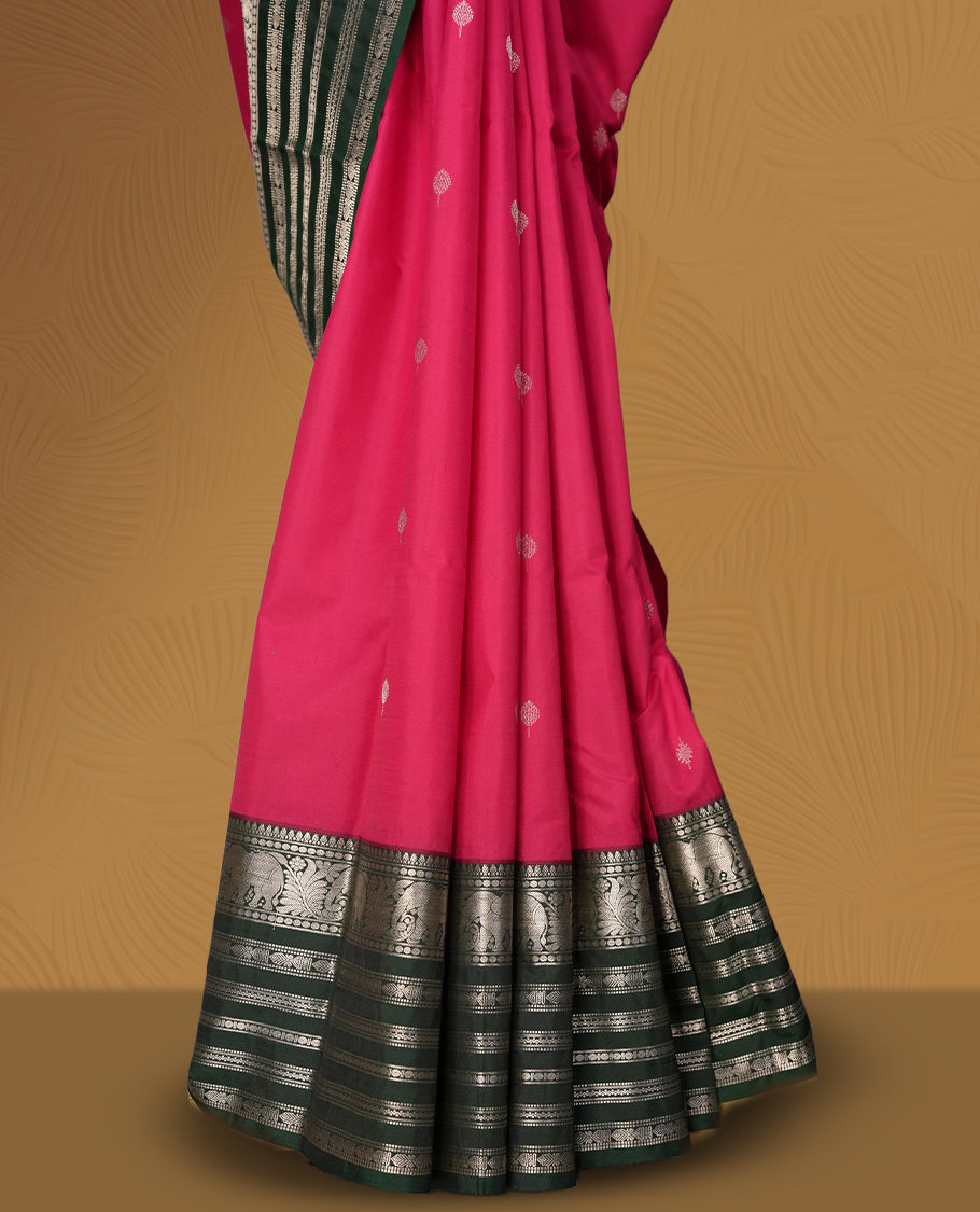 Pink and green colour soft silk saree with rich silver zari border and buttas, paired with a matching blouse.