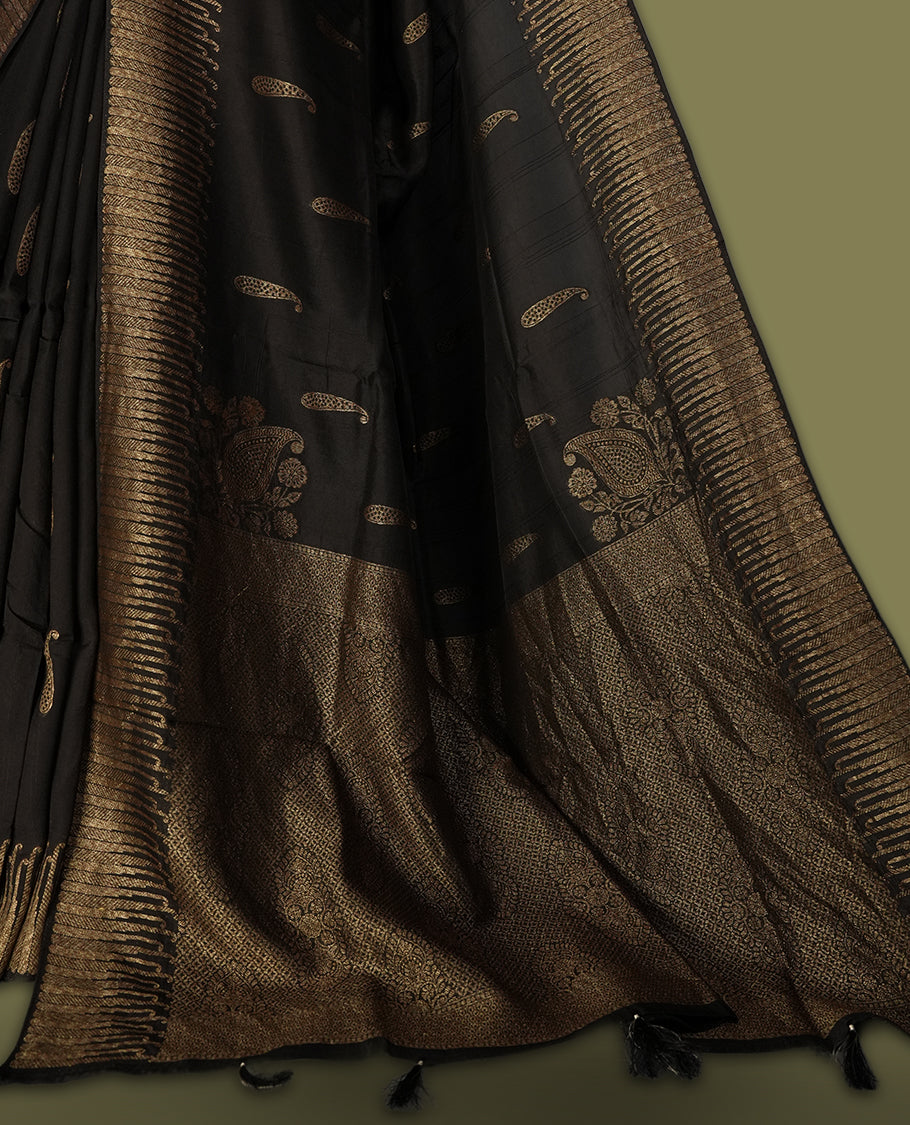 Black colour semi Banarasi Tussar Georgette saree with delicate gold zari buttas on the body, a rich golden zari pallu, and detailed woven border & Comes with a matching blouse piece.