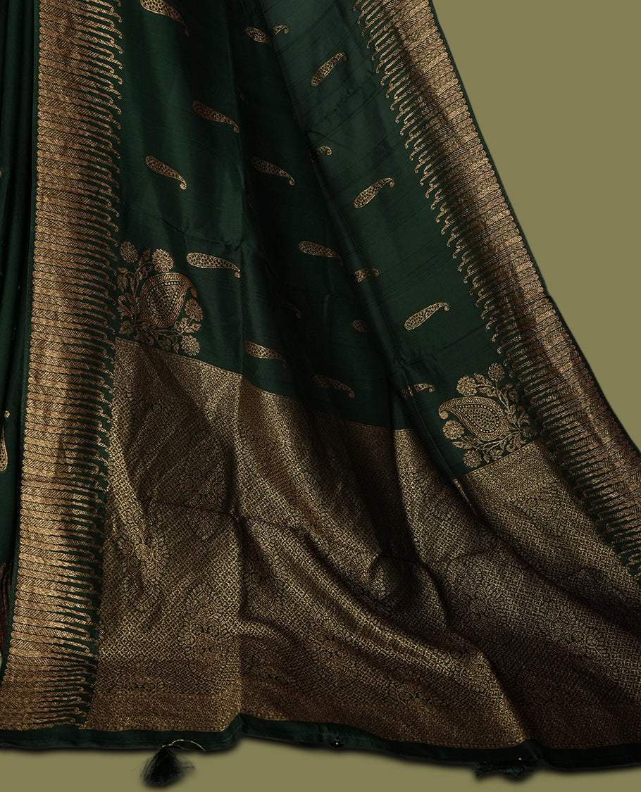 Dark green colour semi Banarasi Tussar Georgette saree with delicate gold zari buttas on the body, a rich golden zari pallu, and detailed woven border & Comes with a matching blouse piece.
