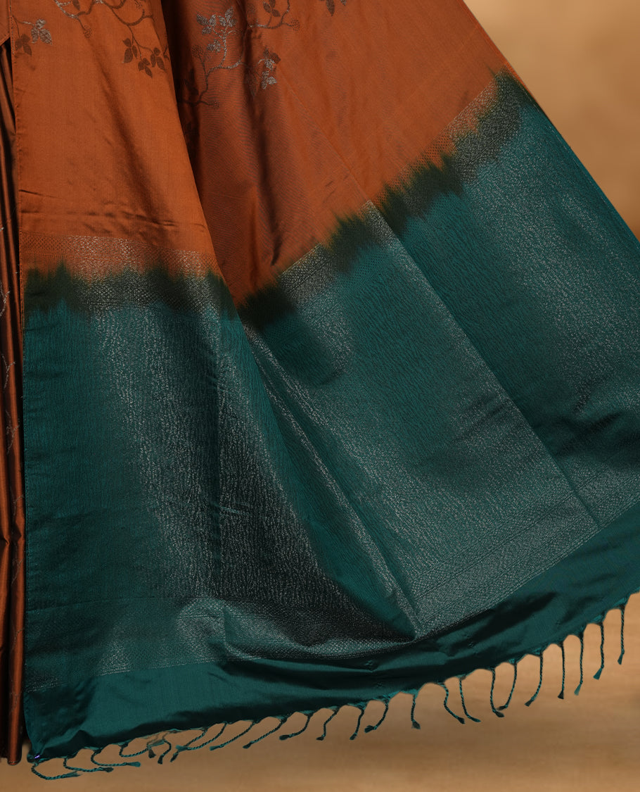 Brown colour soft silk saree featuring Antique zari motifs on body with Highlighting contrast green colour pallu and paired with matching blouse piece.