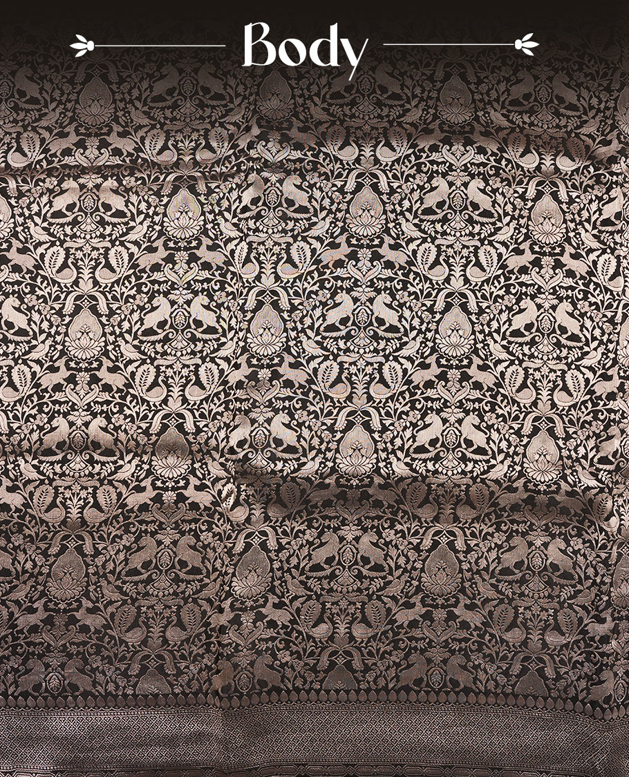 Black colour Mysore Crepe Silk saree fearturing gold Zari kodi visiri & Animal brocade pattern on body and self colour border paired with matching blouse